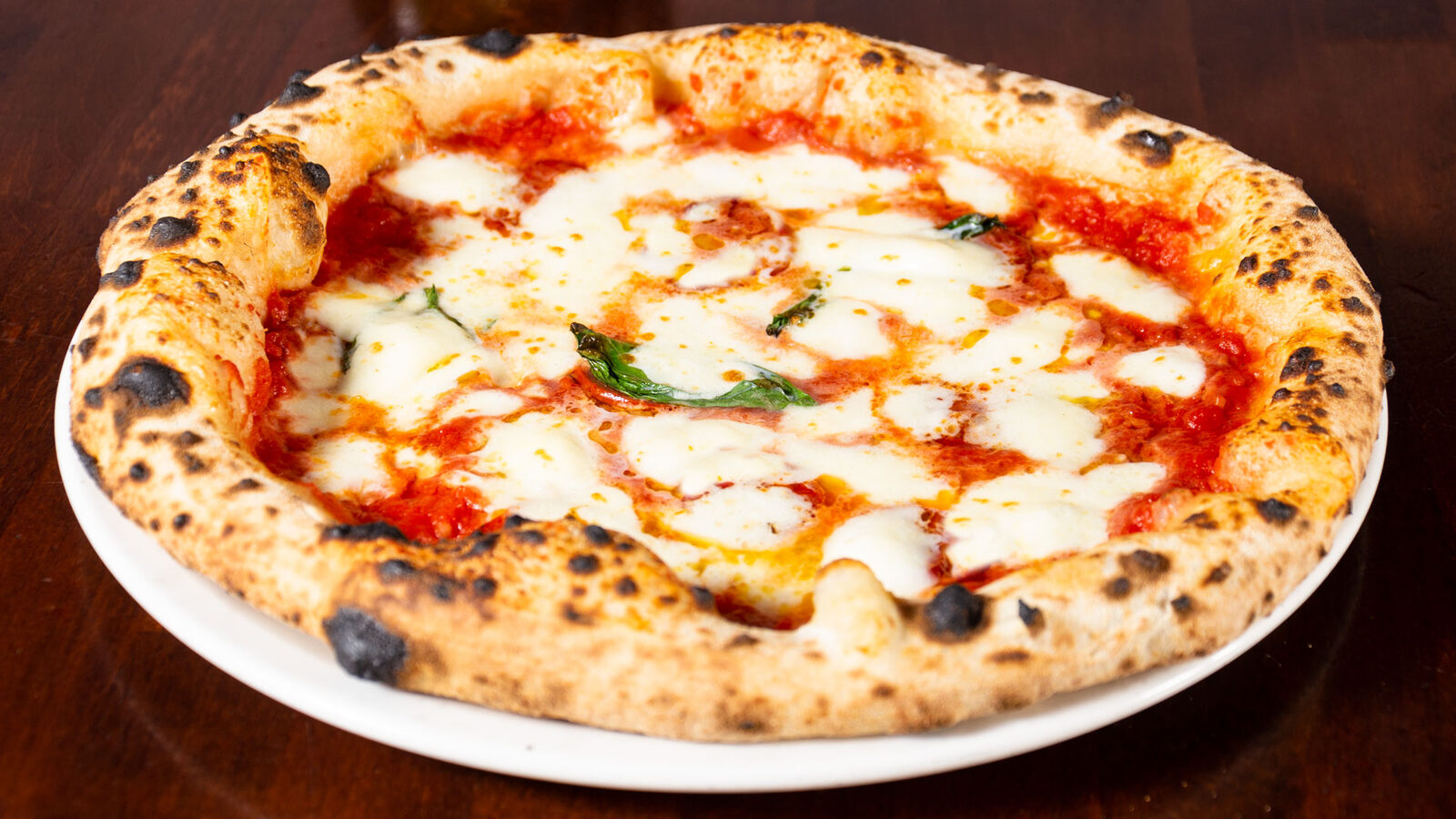Close-up of a wood-fired Neapolitan margherita pizza